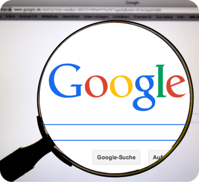 Google search page with magnify glass over the top